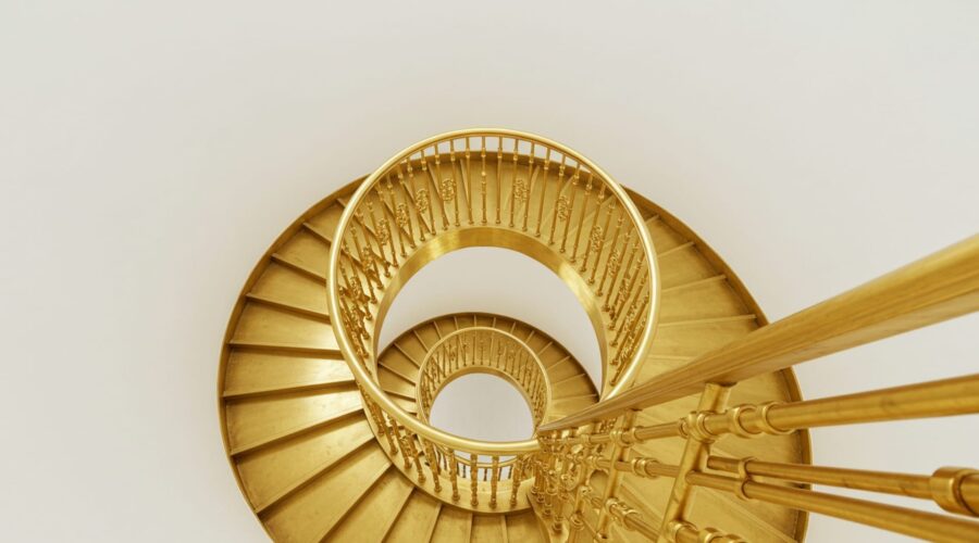 Photo-of-a-beautiful-golden-spiral-staircase-like-the-emotional-scale-for-alignment